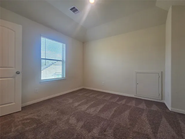 a view of a hallway with closet and window