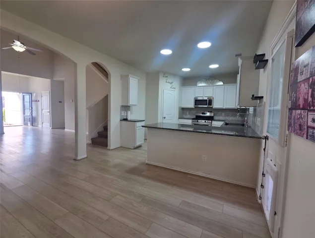 a kitchen with stainless steel appliances granite countertop a refrigerator sink and cabinets