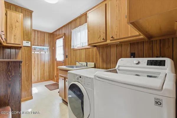 a bathroom with a granite countertop sink a toilet and a mirror