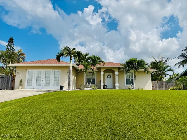 a front view of a house with a garden