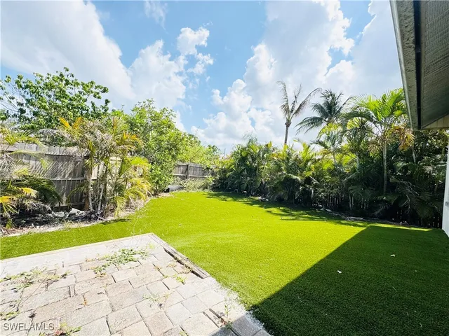 a view of a swimming pool and trees in the background