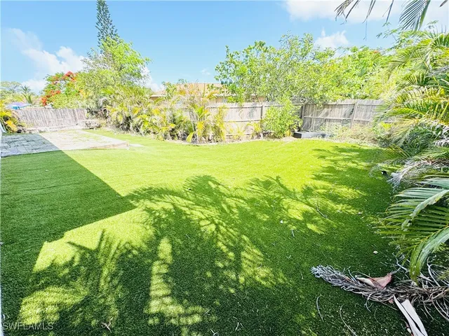 a garden with trees in the background
