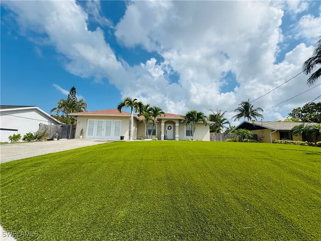 a front view of a house with a yard