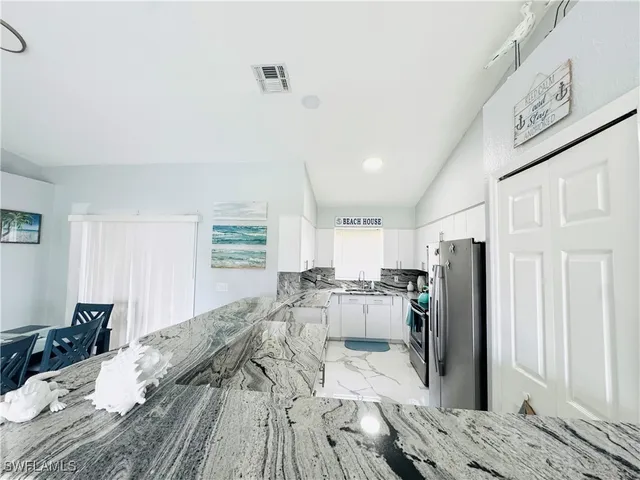 a bed room with a bed and a refrigerator