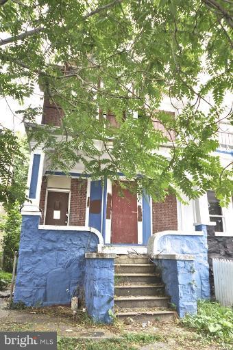 2906 Riggs Avenue Baltimore, MD 21216 - Photo 6 of 6 a front view of a house with a garden