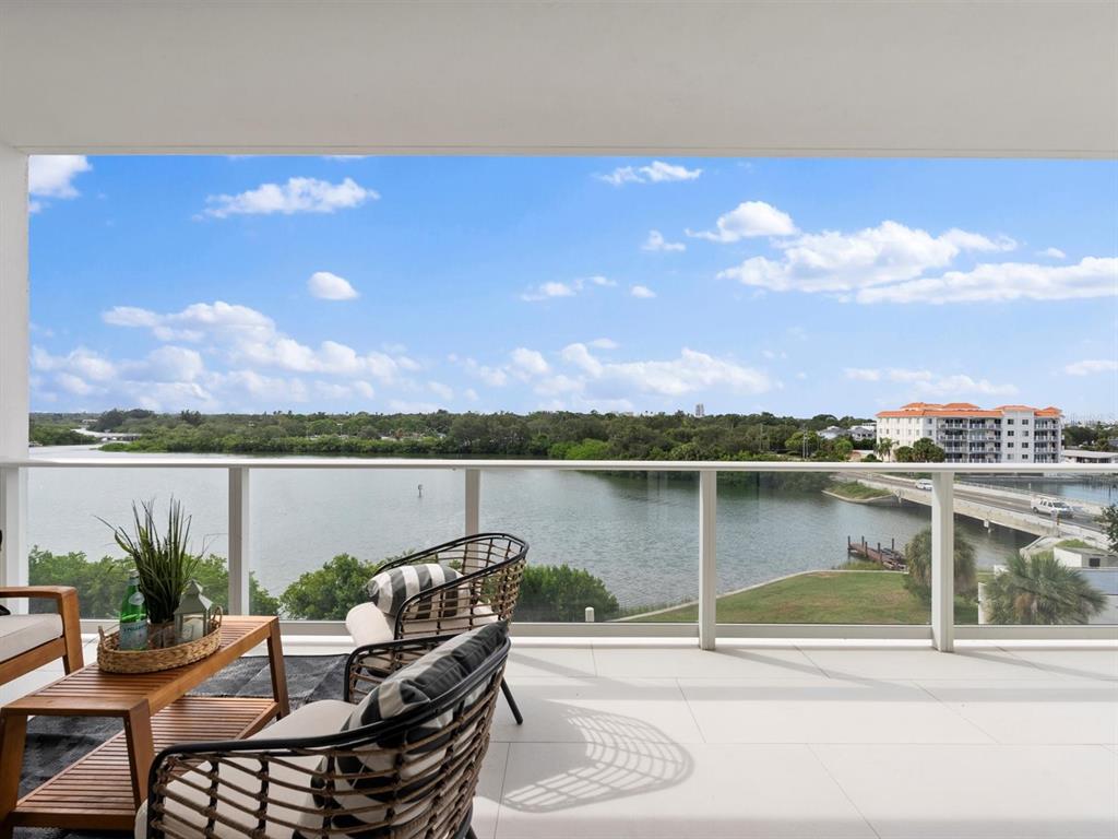 1020 Sunset Point Road, Unit 410 Clearwater, FL 33755 - Photo 12 of 27 a view of a lake with a table and chairs