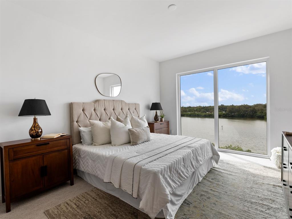 1020 Sunset Point Road, Unit 410 Clearwater, FL 33755 - Photo 17 of 27 a bedroom with a bed and a window