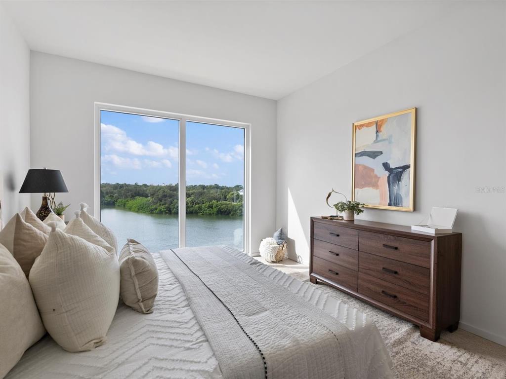 1020 Sunset Point Road, Unit 410 Clearwater, FL 33755 - Photo 19 of 27 a room with a bed and large window