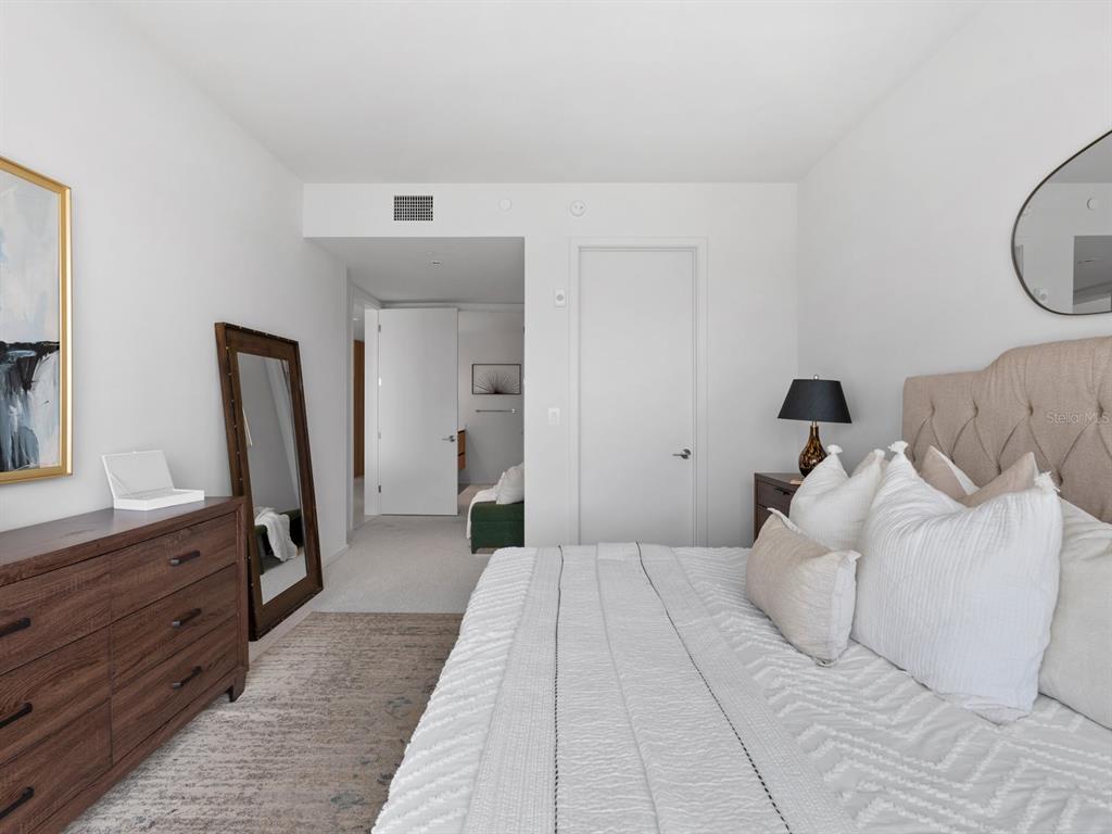 1020 Sunset Point Road, Unit 410 Clearwater, FL 33755 - Photo 20 of 27 a bedroom with a bed and a dresser