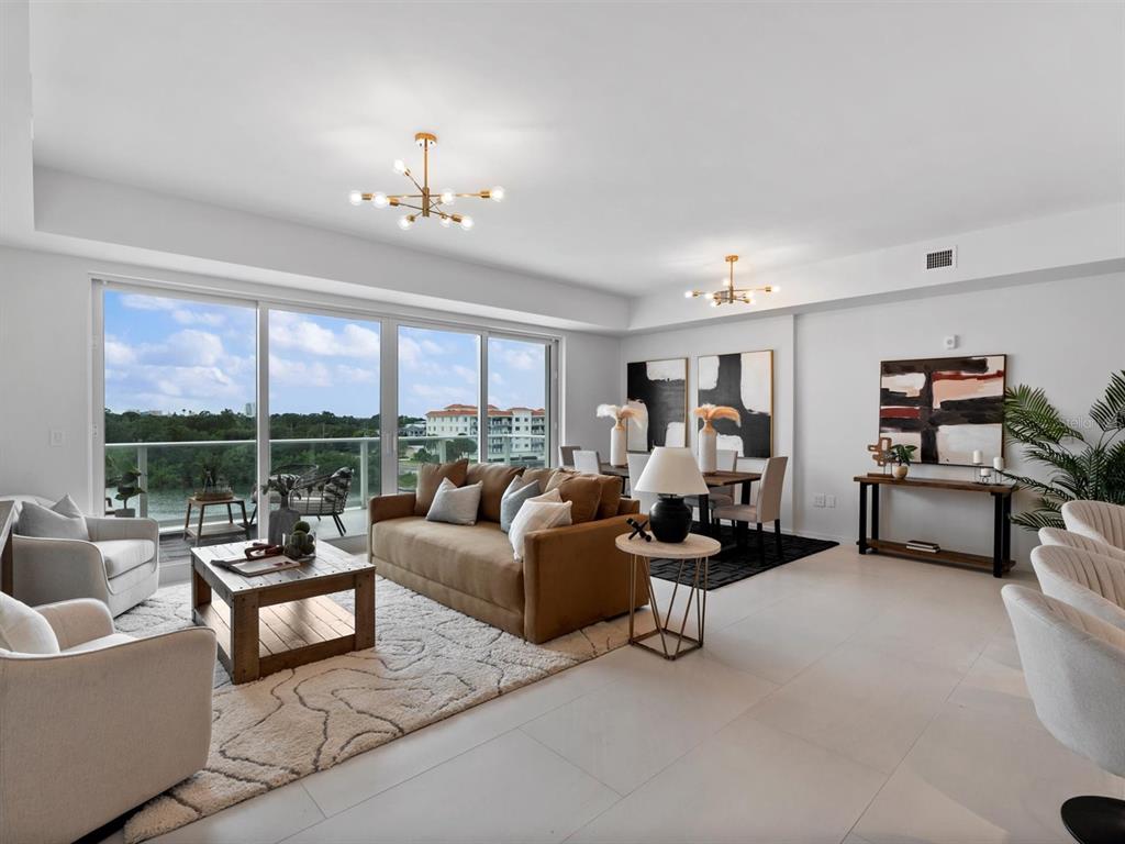 1020 Sunset Point Road, Unit 410 Clearwater, FL 33755 - Photo 2 of 27 a living room with furniture and a large window