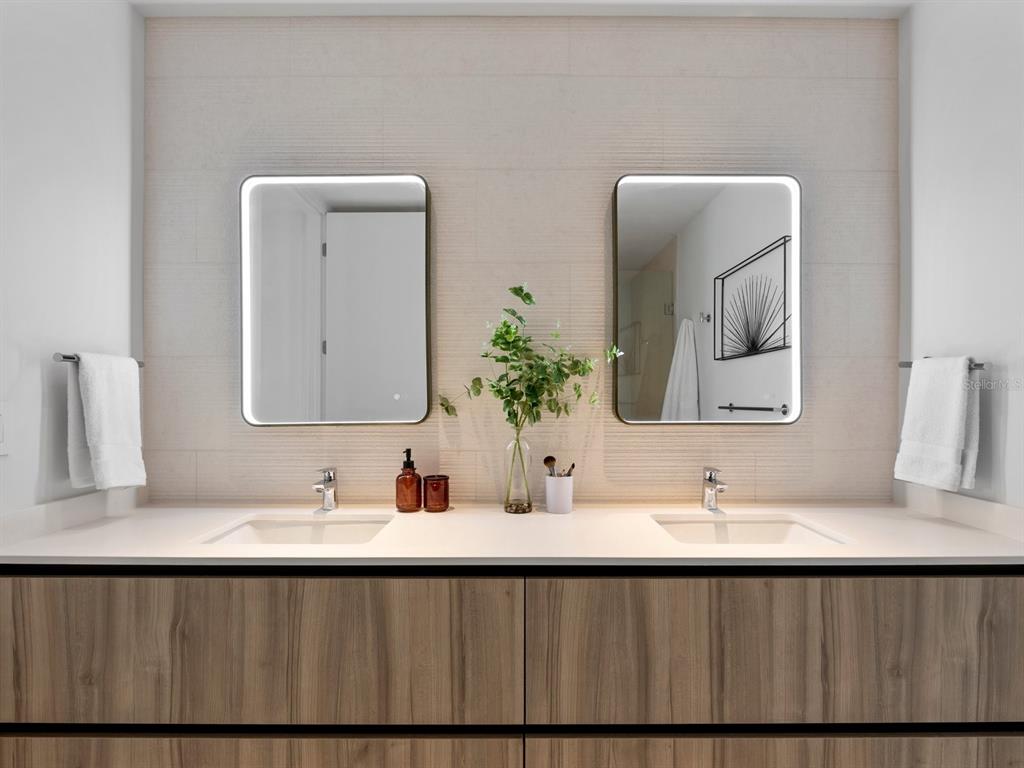 1020 Sunset Point Road, Unit 410 Clearwater, FL 33755 - Photo 21 of 27 a bathroom with a double vanity sink and a mirror