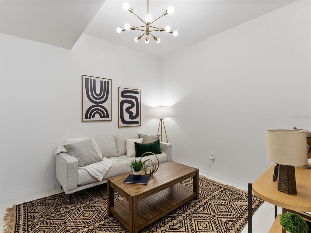 1020 Sunset Point Road, Unit 410 Clearwater, FL 33755 - Photo 23 of 27 a living room with furniture and a table