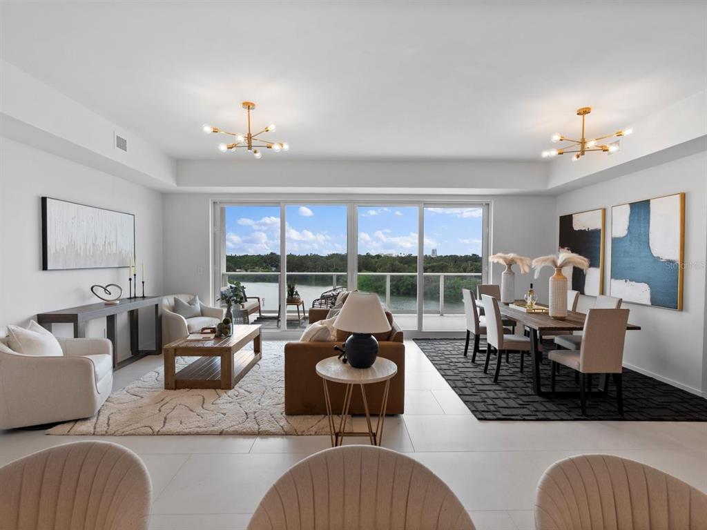 1020 Sunset Point Road, Unit 410 Clearwater, FL 33755 - Photo 5 of 27 a living room with furniture large window and a table