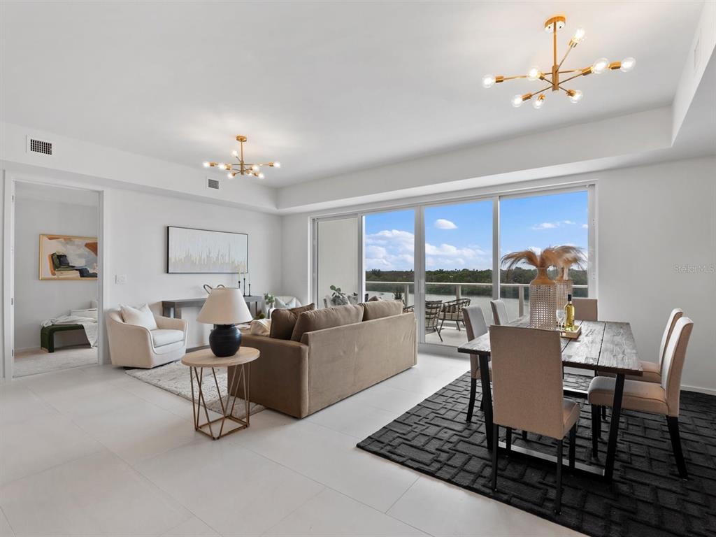 1020 Sunset Point Road, Unit 410 Clearwater, FL 33755 - Photo 6 of 27 a dining room with furniture a chandelier and window