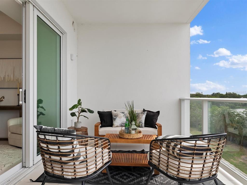 1020 Sunset Point Road, Unit 410 Clearwater, FL 33755 - Photo 9 of 27 a living room with furniture and a potted plant