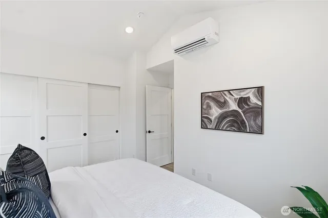 a bedroom with a bed and a painting on the wall