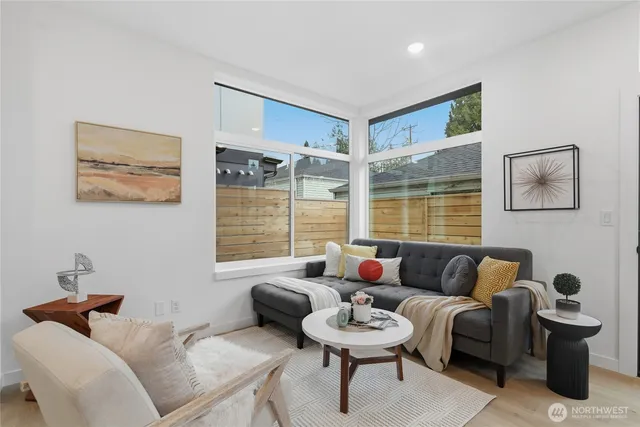 a living room with furniture and a large window
