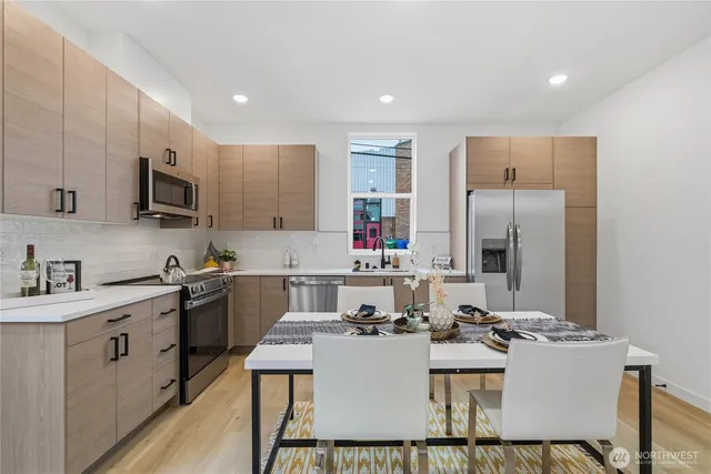 a kitchen with a sink appliances and cabinets