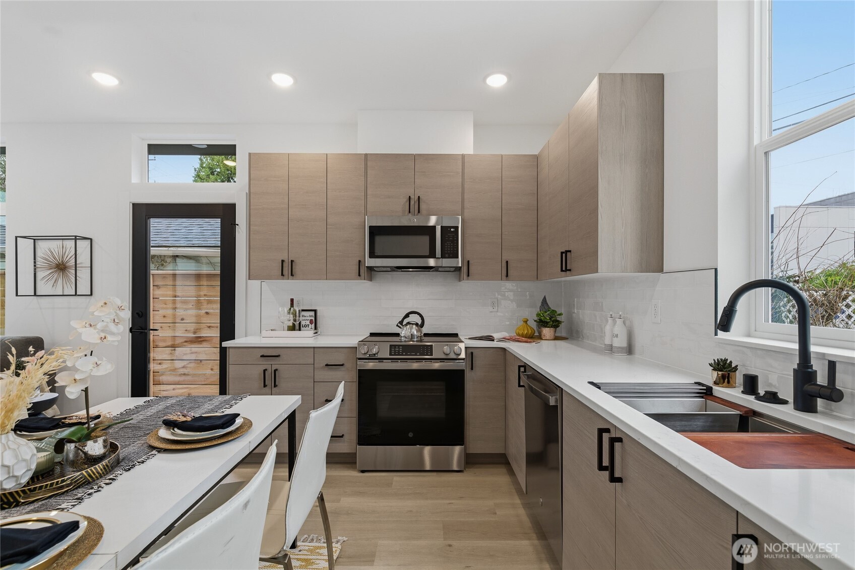 805 South Sullivan Street Seattle, WA 98108 - Photo 6 of 20 a kitchen with a sink a stove and cabinets