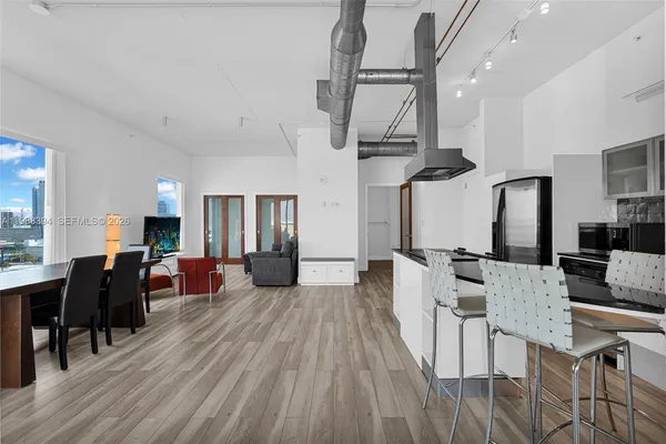 a living room with lots of furniture and kitchen view