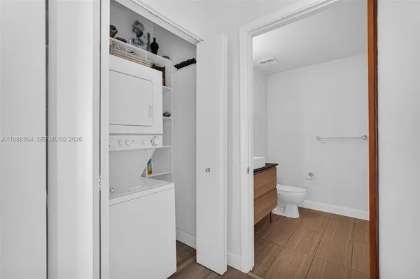 a view of bathroom with a toilet a sink and a mirror