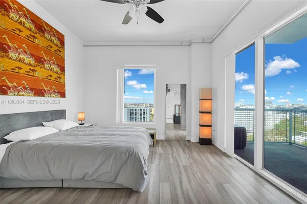 a bedroom with a bed and glass door