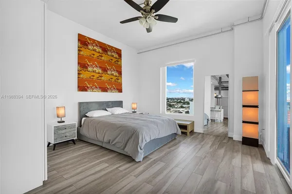 a bedroom with a large bed and a window