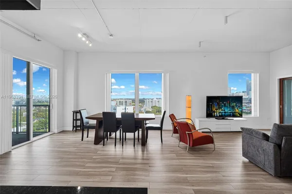 a view of a dining room with furniture window and wooden floor