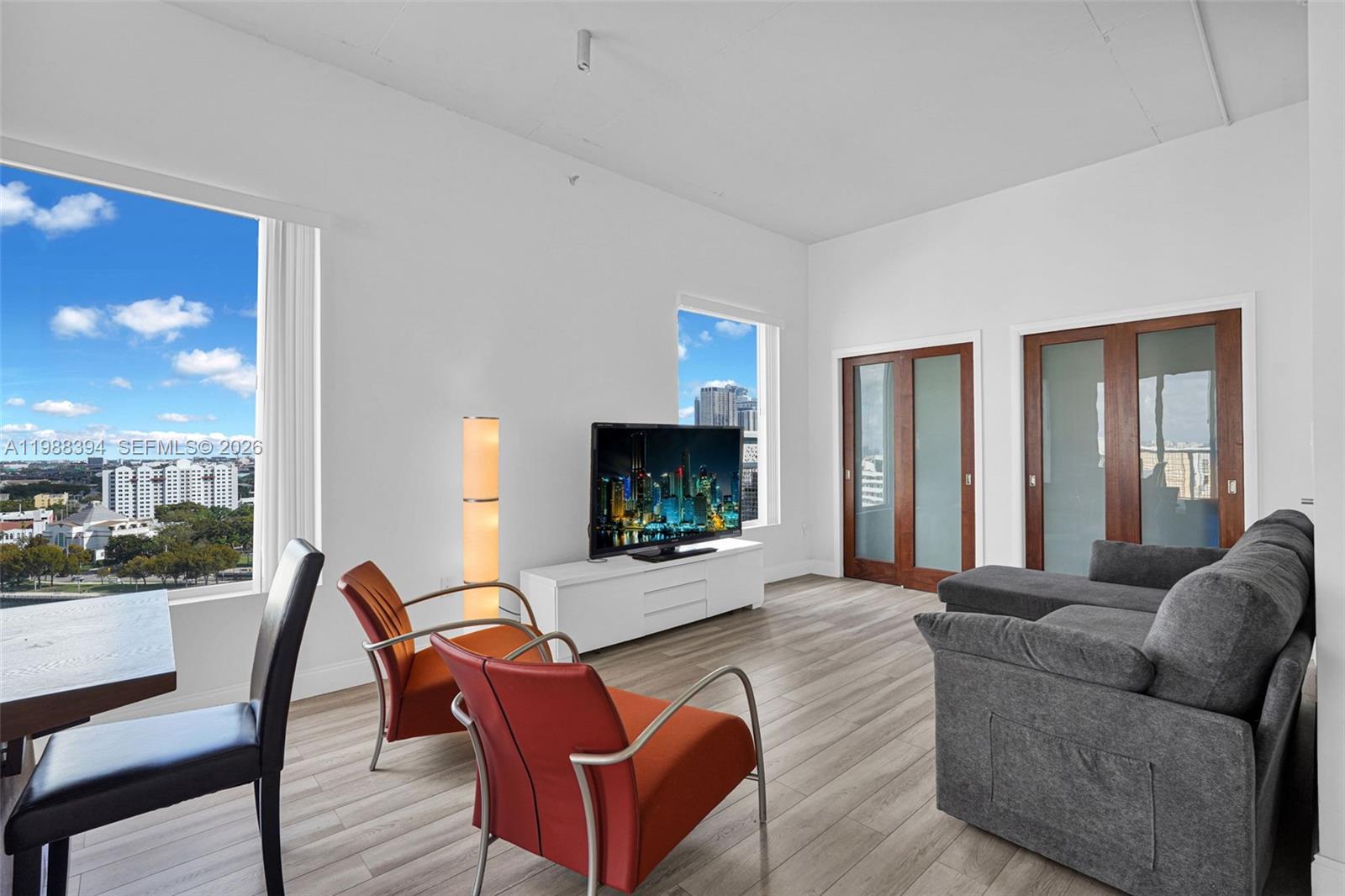 10 Southwest South River Drive, Unit 1615 Miami, FL 33130 - Photo 9 of 28 a living room with furniture and a flat screen tv