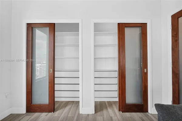 a view of walk in closet with empty racks