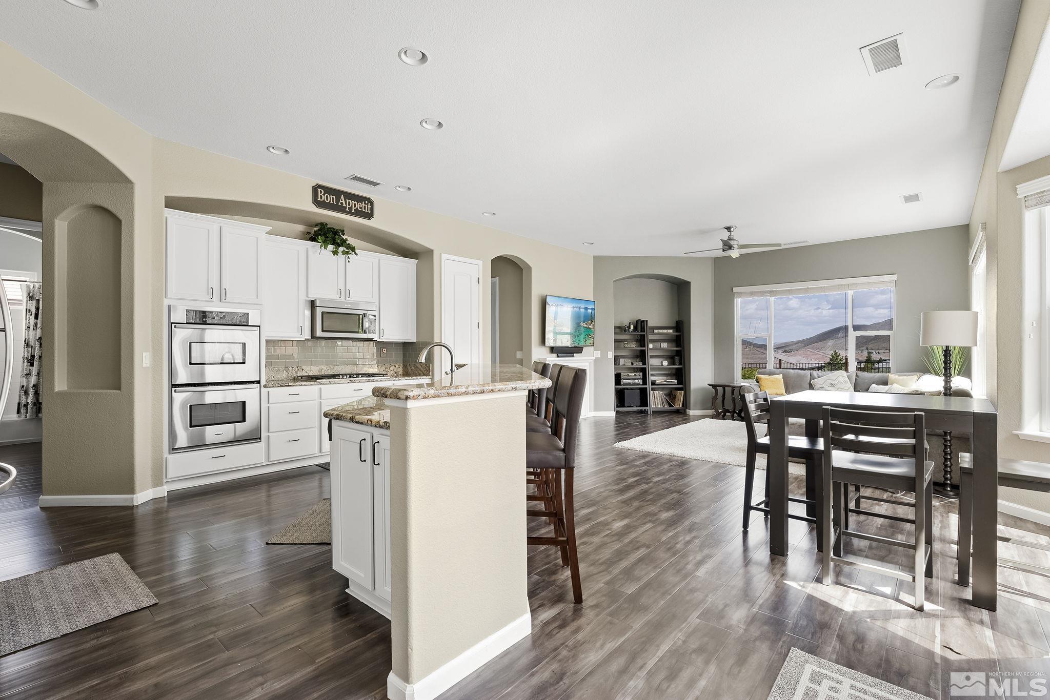 2915 Bull Rider Drive Reno, NV 89521 - Photo 6 of 34 a kitchen with a table chairs refrigerator and cabinets