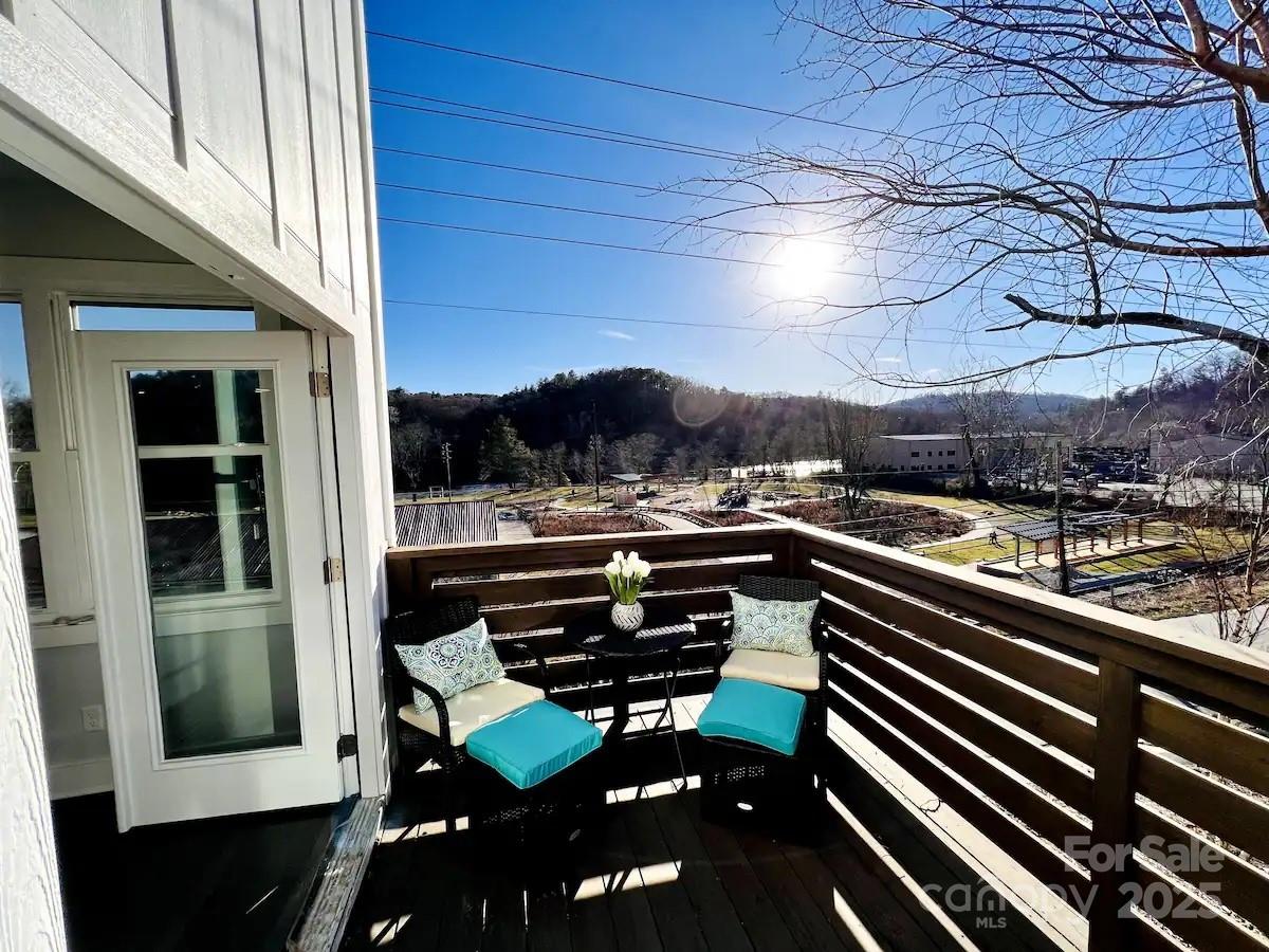 1057 Riverside Drive Asheville, NC 28804 - Photo 2 of 42 a view of a balcony with chairs