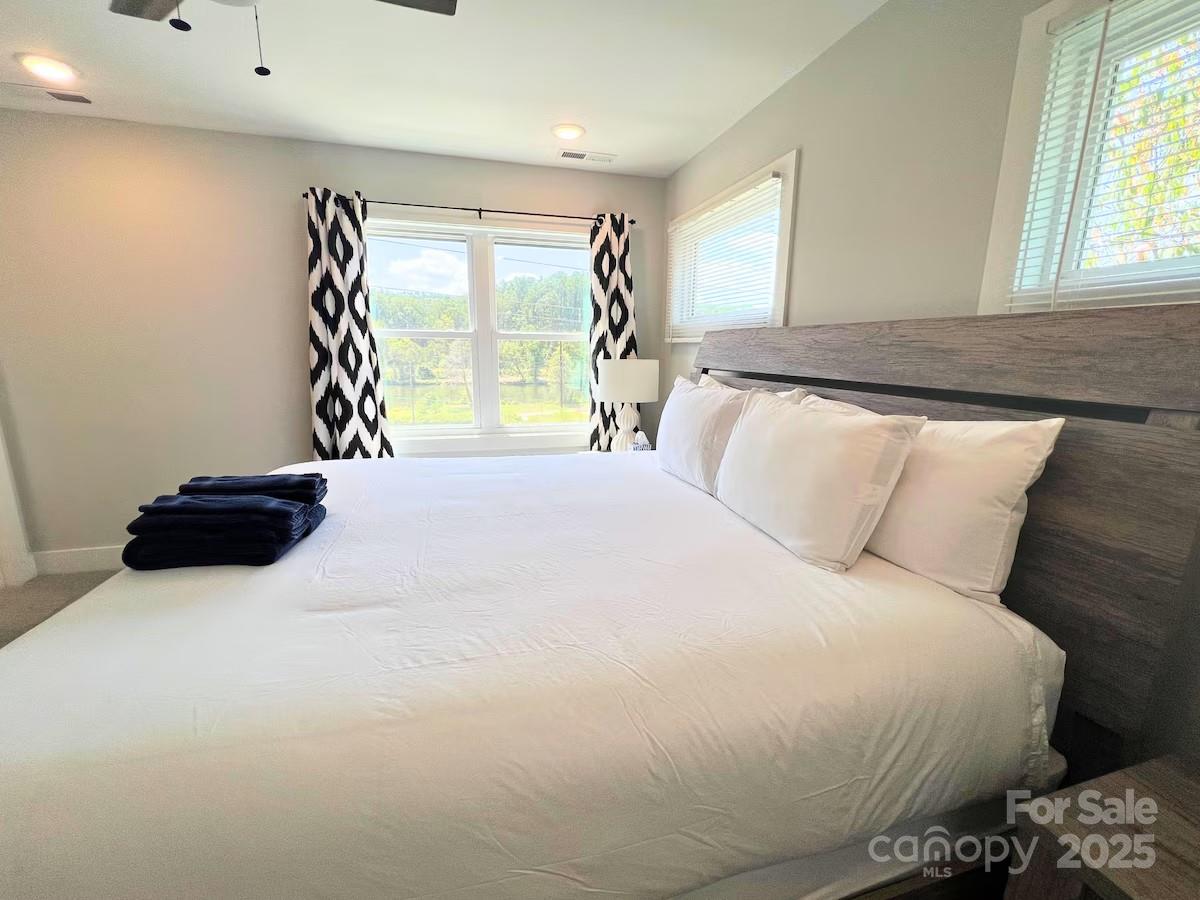 1057 Riverside Drive Asheville, NC 28804 - Photo 22 of 42 a bedroom with a bed and a large window