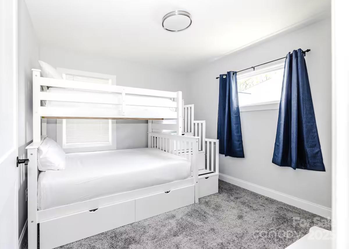 1057 Riverside Drive Asheville, NC 28804 - Photo 26 of 42 a bedroom with a bed and a window