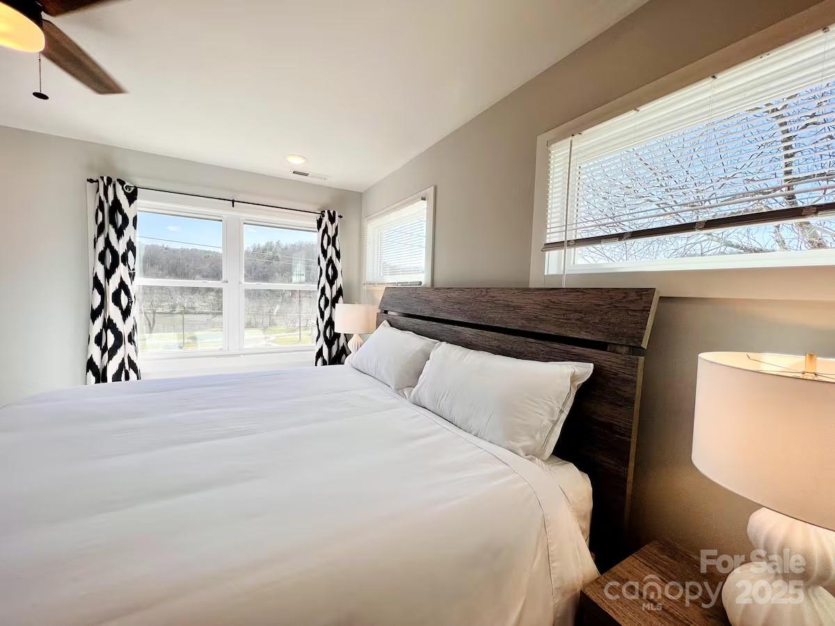 1057 Riverside Drive Asheville, NC 28804 - Photo 30 of 42 a bedroom with a bed and a window