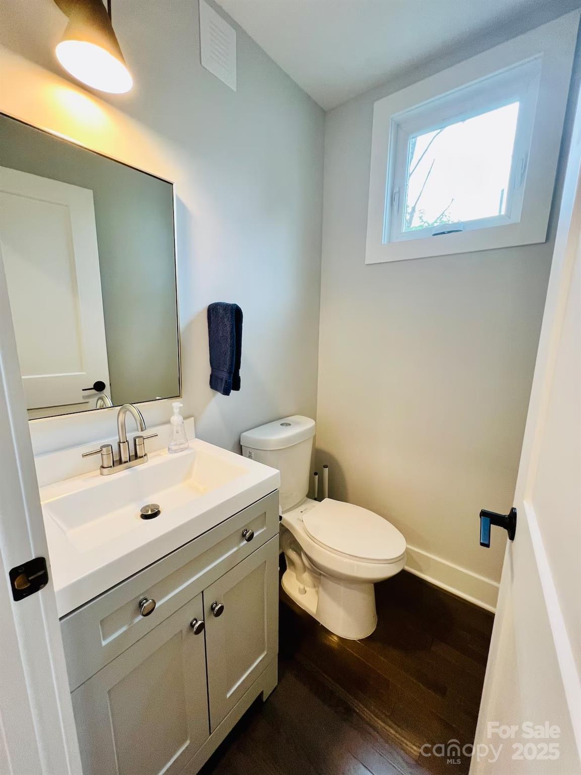 1057 Riverside Drive Asheville, NC 28804 - Photo 31 of 42 a bathroom with a toilet sink and mirror