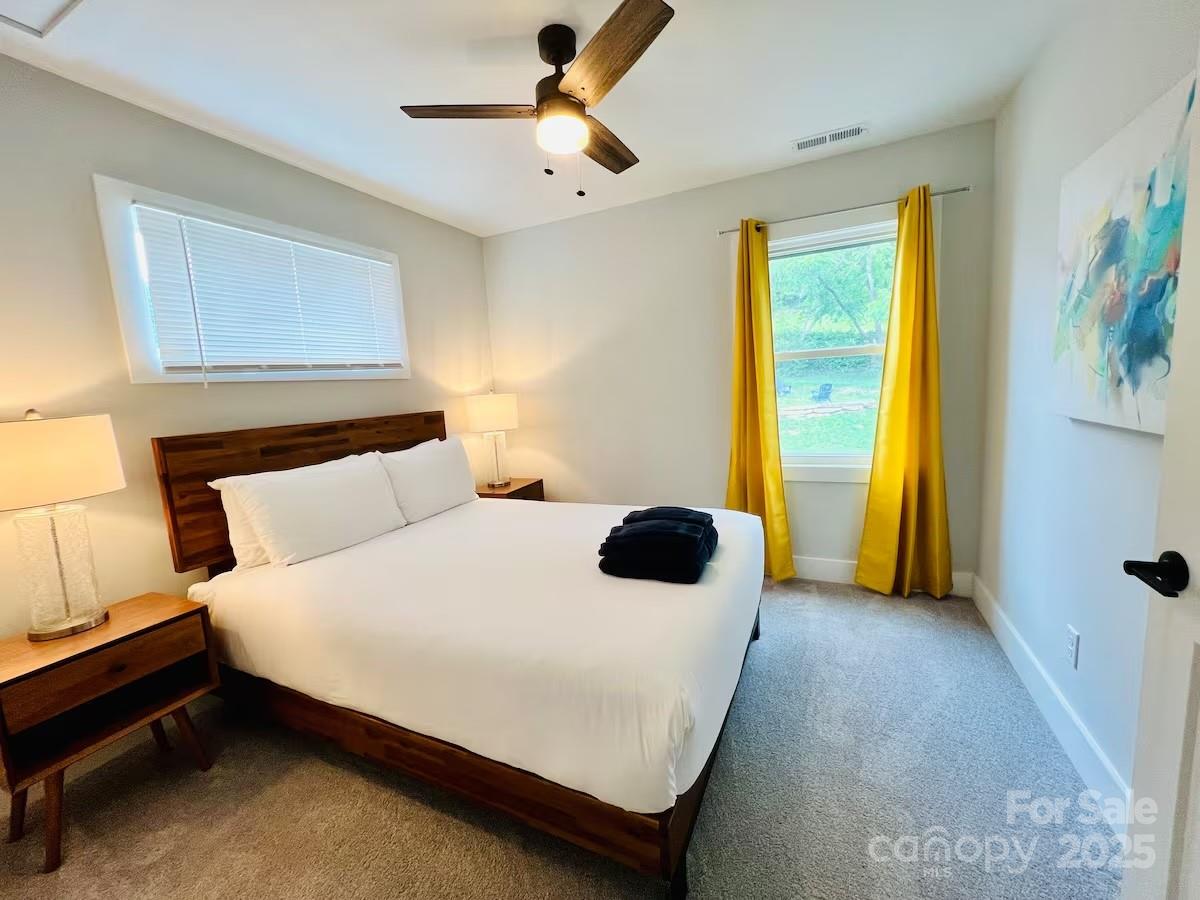 1057 Riverside Drive Asheville, NC 28804 - Photo 32 of 42 a bedroom with a bed and a window