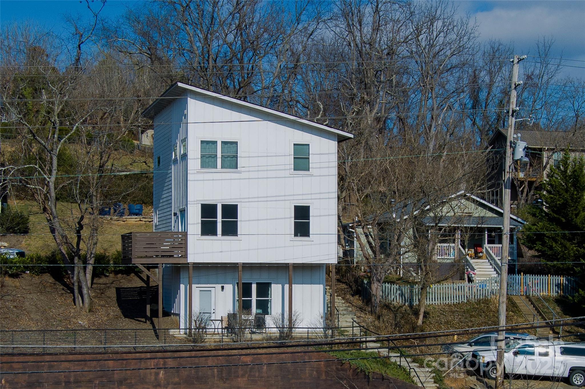 1057 Riverside Drive Asheville, NC 28804 - Photo 34 of 42 a view of a white house with large windows