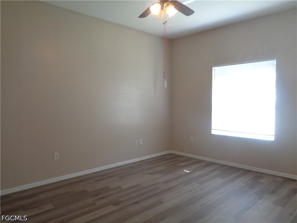 2463 Nature Pointe Loop Fort Myers, FL 33905 - Photo 22 of 50 an empty room with wooden floor and windows