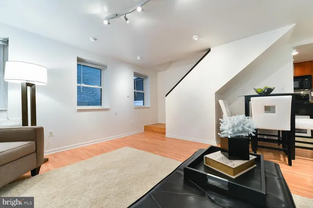 a bedroom with furniture and a wooden floor