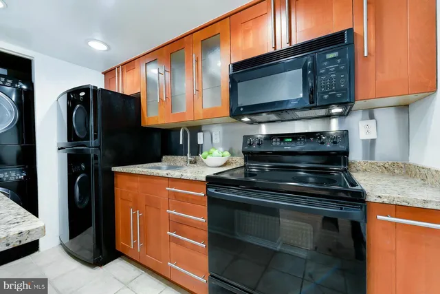 a kitchen with stainless steel appliances granite countertop a stove microwave and refrigerator