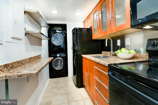 a kitchen with stainless steel appliances granite countertop a stove and a refrigerator