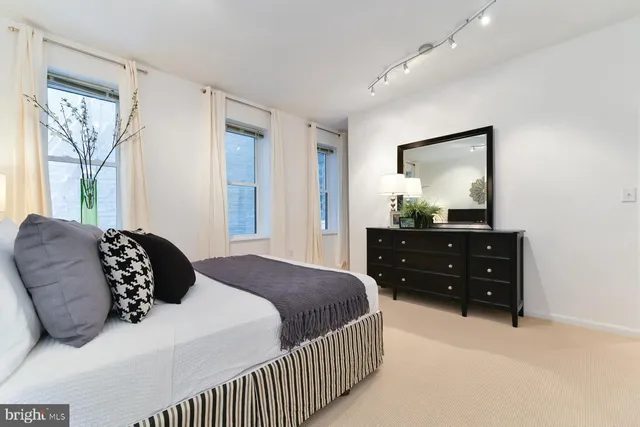 a bedroom with a bed and a dresser