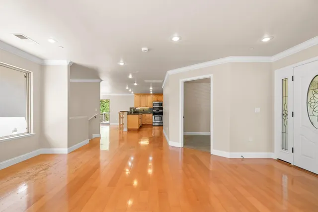a view of a livingroom with furniture a dinning room and kitchen view