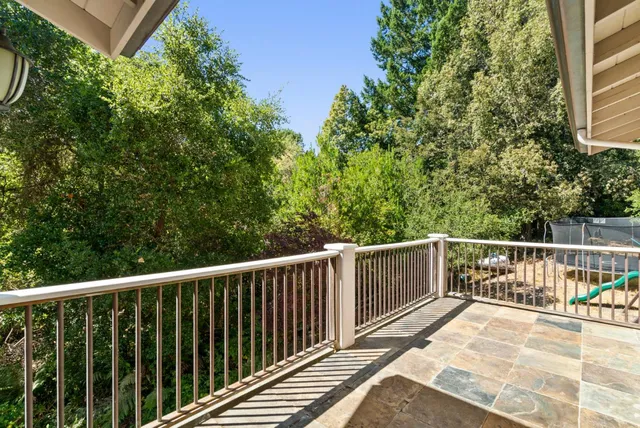 a view of a balcony with wooden floor