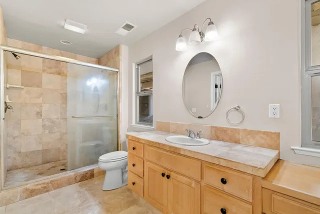 a view of a yard and tree in front of it