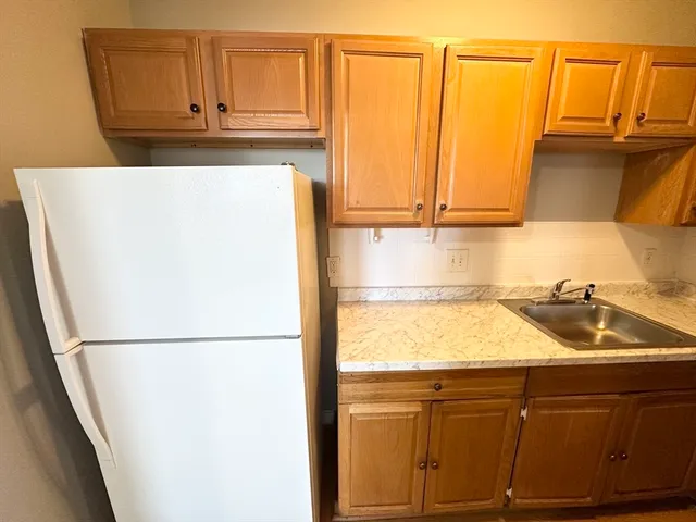 a kitchen with a sink and a refrigerator