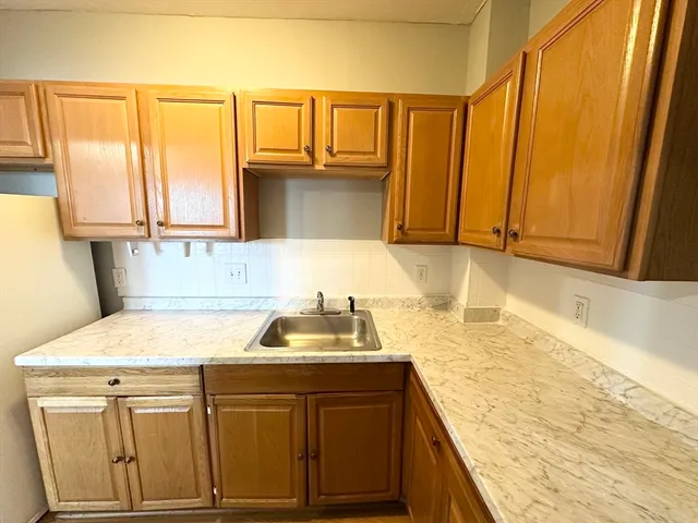 a kitchen with a sink and a window