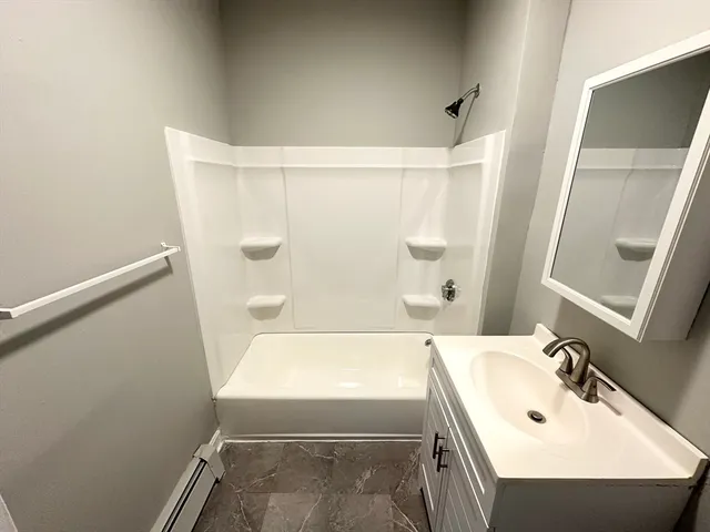 a bathroom with a sink a mirror and a shower