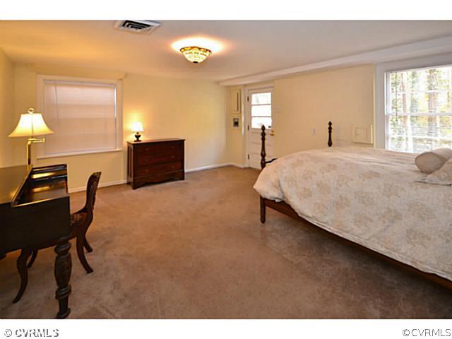 4411 Knob Road Richmond, VA 23235 - Photo 8 of 18 a bedroom with a bed and a table